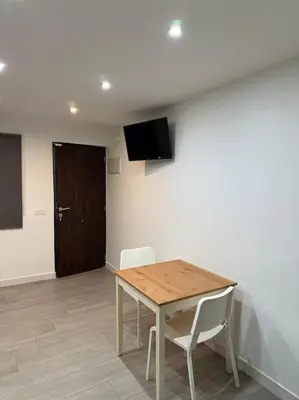 a room with a table and two chairs and a door at Precioso apartamento 2 personas in Valencia