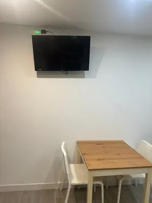 a table and chairs with a television on a wall at Precioso apartamento 2 personas in Valencia