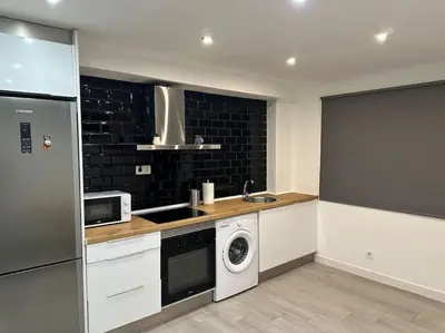 a kitchen with a sink and a washer and dryer at Precioso apartamento 2 personas in Valencia