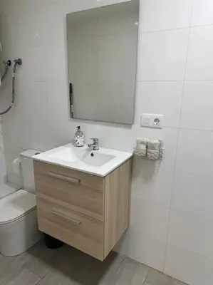 a bathroom with a sink and a toilet and a mirror at Precioso apartamento 2 personas in Valencia