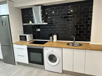 a kitchen with a washing machine and a sink at Precioso apartamento 2 personas in Valencia