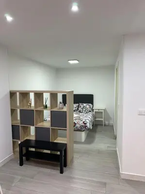 a bedroom with a bed and a bench in a room at Precioso apartamento 2 personas in Valencia