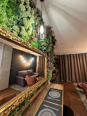 a living room with a couch and plants on the wall at Fabulosa vivienda nueva a un paso de Plaza EspañA in Valencia