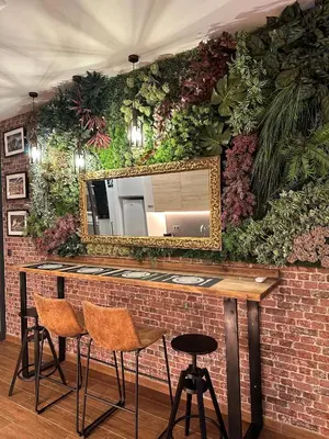 a bar with a mirror on a wall with plants at Fabulosa vivienda nueva a un paso de Plaza EspañA in Valencia