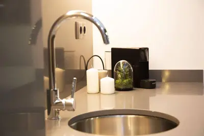 a kitchen counter with a sink and a faucet at Magnifica vivienda a estrenar junto a Plaza España in Valencia