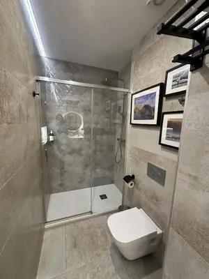 a bathroom with a shower and a white toilet at Magnifica vivienda a estrenar junto a Plaza España in Valencia