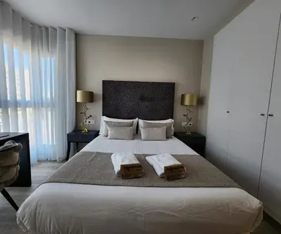 a bedroom with a large bed with two pillows on it at MD Pont de Fusta in Valencia
