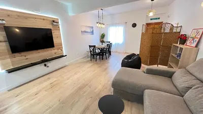 a living room with a couch and a flat screen tv at La Casica de los Abuelos By El Conserje in Pedralba