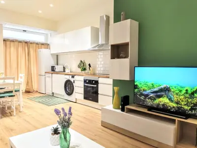 a living room with a flat screen tv in a kitchen at Apartamento en Valencia centro in Valencia