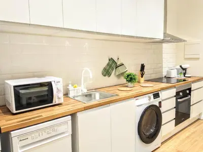 a white kitchen with a microwave and a sink at Apartamento en Valencia centro in Valencia