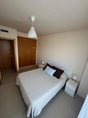 a bedroom with a large white bed with a pillow at Apartamento en Playa moncófar a tan solo 300 metros in Moncófar