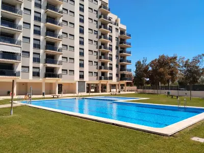 a swimming pool in front of a large apartment building at Apartamento en Playa moncófar a tan solo 300 metros in Moncófar