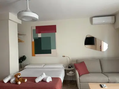 a living room with a bed and a couch at Osito Hub - Pintor Nicolau in Valencia