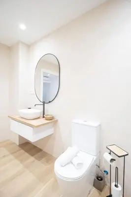 a white bathroom with a toilet and a mirror at BedTime Suites by Concept Flats in Valencia