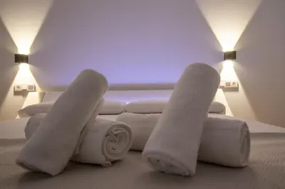 a room with a couch and two pairs of socks at BedTime Suites by Concept Flats in Valencia