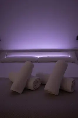 three rolls of toilet paper sitting on the floor at BedTime Suites by Concept Flats in Valencia