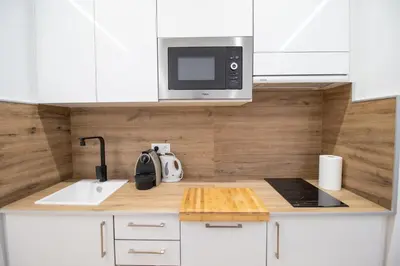 a kitchen with a sink and a microwave at BedTime Suites by Concept Flats in Valencia