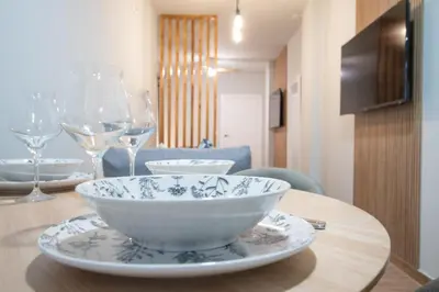 a bowl on a table with wine glasses on it at Suite Parque del Turia by Concept Flats in Valencia