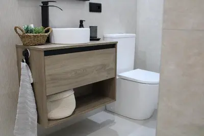 a bathroom with a sink and a toilet at Las Arenas Suites 2 Playa in Valencia