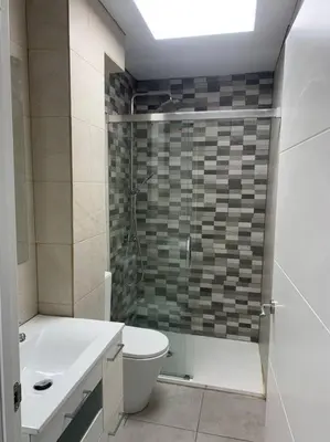 a bathroom with a shower and a toilet and a sink at Aerofira Paterna in Paterna