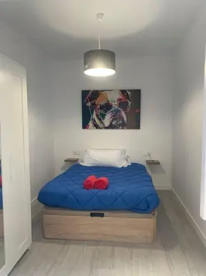 a bedroom with a bed with two red pillows on it at Aerofira Paterna in Paterna