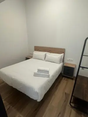 a bedroom with a bed with white sheets and pillows at Portobeach Valencia Suites in Valencia