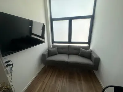 a living room with a couch and a flat screen tv at Portobeach Valencia Suites in Valencia