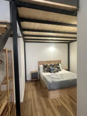 a bedroom with a bed and a loft at Portobeach Valencia Suites in Valencia