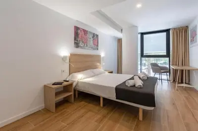 a bedroom with a bed and a desk and a chair at Duplex 6 pax 2 BTH, excelent area luxor in Valencia