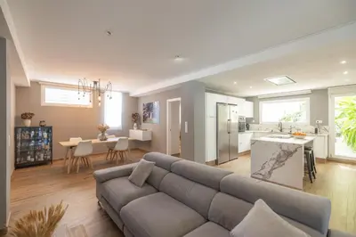 a large living room with a couch and a kitchen at Calm House, a 10 min playa de la de Cullera in Llaurí