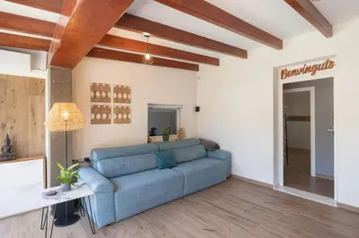 a living room with a blue couch in a room at Calm House, a 10 min playa de la de Cullera in Llaurí