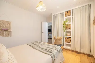 a white bedroom with a bed and a window at Calm House, a 10 min playa de la de Cullera in Llaurí