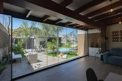 a living room with a large glass door leading to a patio at Calm House, a 10 min playa de la de Cullera in Llaurí