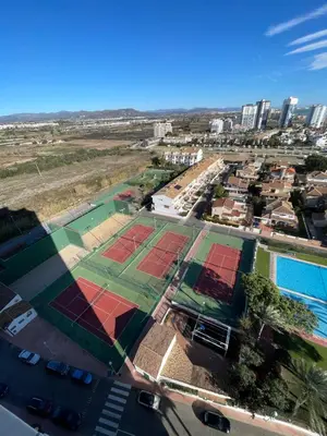 an aerial view of tennis courts in a city at Bungalow on the beach 15 minutes from Valencia in Valencia