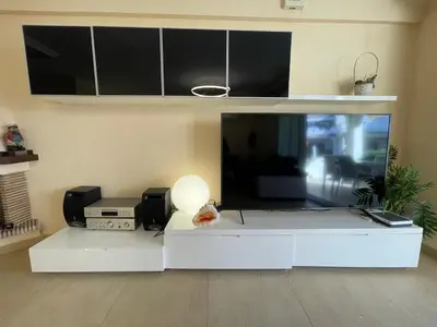 a living room with a white table and a microwave at Bungalow on the beach 15 minutes from Valencia in Valencia