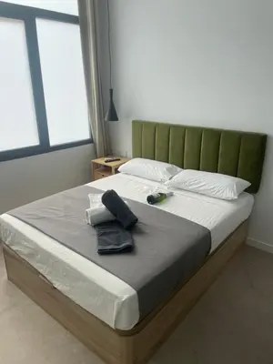 a bedroom with a large bed with a green headboard at Mar&Sol Flats by Vivo GC in Valencia