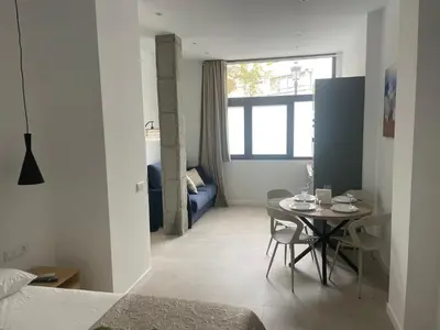a small room with a table and a bed at Mar&Sol Flats by Vivo GC in Valencia