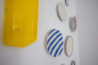 a group of plates and mirrors on a wall at FLORIT FLATS - Quiet and Cozy Studios by the Joaquin Sorolla Station in Valencia