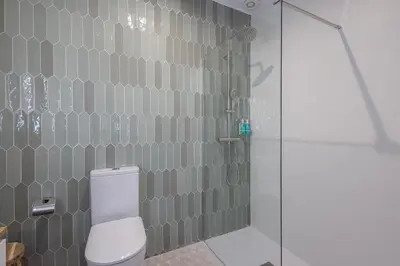 a bathroom with a shower and a white toilet at FLORIT FLATS - Quiet and Cozy Studios by the Joaquin Sorolla Station in Valencia