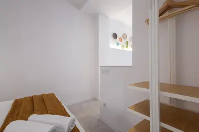 a room with a bed and a glass staircase at FLORIT FLATS - Quiet and Cozy Studios by the Joaquin Sorolla Station in Valencia