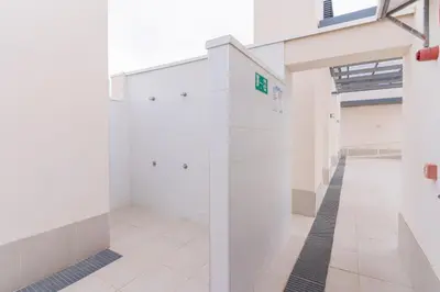 a hallway in a building with white walls at Canet Seaview Gem: Pool & Beach Proximity in Canet de Berenguer