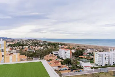an aerial view of a city and the ocean at Canet Seaview Gem: Pool & Beach Proximity in Canet de Berenguer