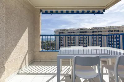 a balcony with a table and chairs and a view at ApartUP Patacona Infinity in Valencia