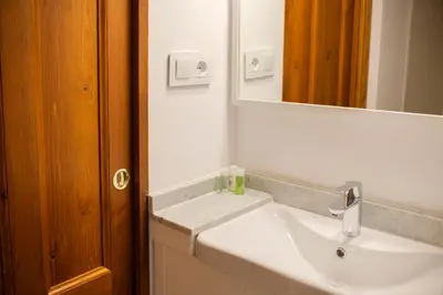 a bathroom with a white sink and a mirror at Ad Hoc Carmen in Valencia