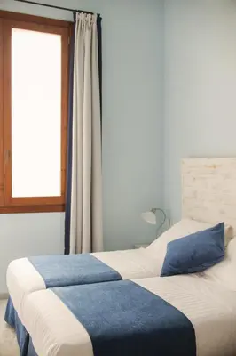 two beds in a bedroom with a window at Ad Hoc Carmen in Valencia