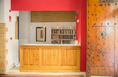 a bar with a red wall and a wooden door at Ad Hoc Carmen in Valencia
