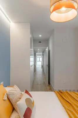 a bedroom with a bed and a chandelier at Malvarrosa Beach Stay! in Valencia