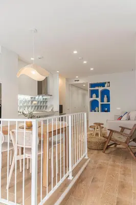 a kitchen and living room with a table and chairs at Malvarrosa Beach Stay! in Valencia