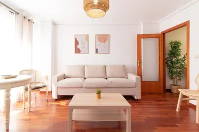 a living room with a couch and a table at Global Vacacional, Apartamento cerca de la playa en Puerto Sagunto in Puerto de Sagunto