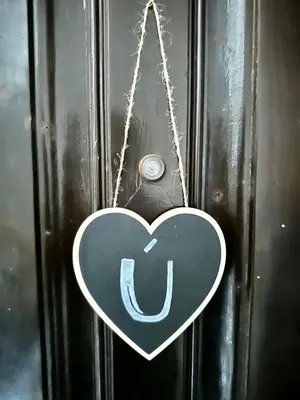 a heart shaped sign hanging on a wall at Casa Únic - Modern Central Home in Ruzafa in Valencia